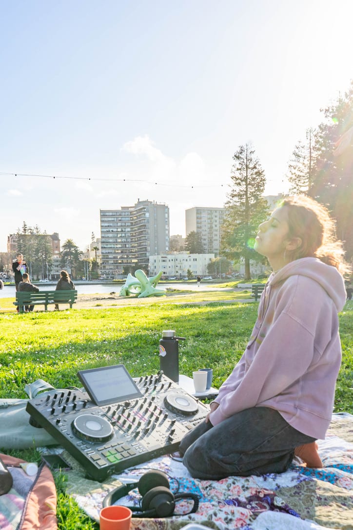 Lake Merritt Set in the sunshine with three friends on the ground
